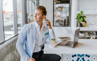 A real estate agent on the phone in a café.