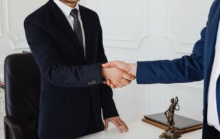 two people shake hands after closing a deal
